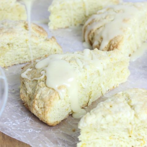 These Fresh Orange Scones are studded with zest and bursting with bright orange flavor! They are the perfect marriage between sweet and tangy flavors. #easyorangescones #glazedorangescones | EverydayMadeFresh.com
