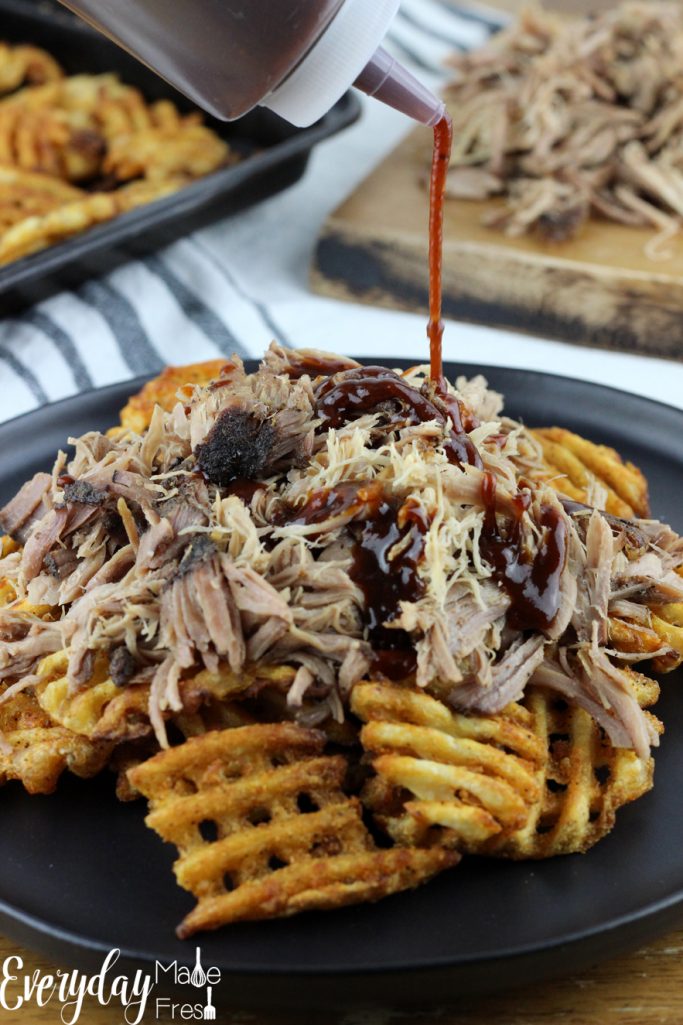 Pork & Waffles is our take on the world famous BBQ Butt Fries.  Waffle fries are the perfect vessel for slow cooked pulled pork, drizzled in BBQ sauce, and topped with fresh scallions. | EverydayMadeFresh.com
