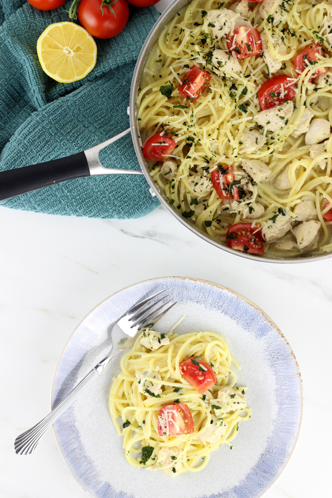 The Best Chicken Spaghetti with Creamy Garlic Sauce is a family favorite! A simple creamy garlic sauce tops spaghetti noodles and lemon and thyme seasoned chicken for a meal that everyone will love.