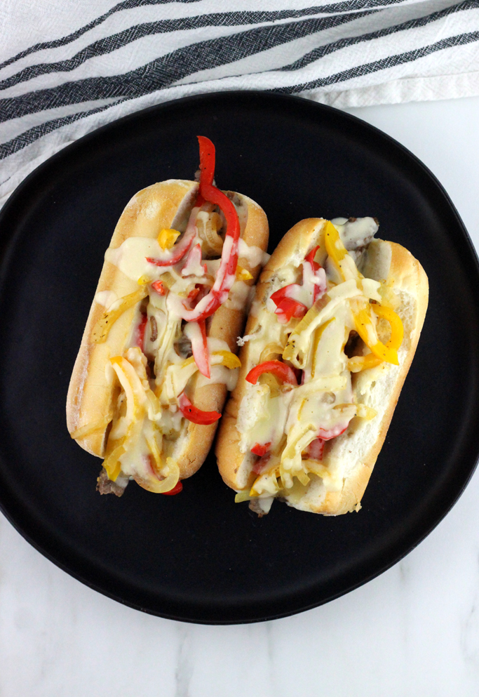 This is no ordinary cheesesteak here. This is The Best Philly Cheesesteak Recipe with Provolone Cheese Sauce.  Ribeye steak, caramelized onions and bell peppers topped with a gooey melty finger licking good cheese sauce!