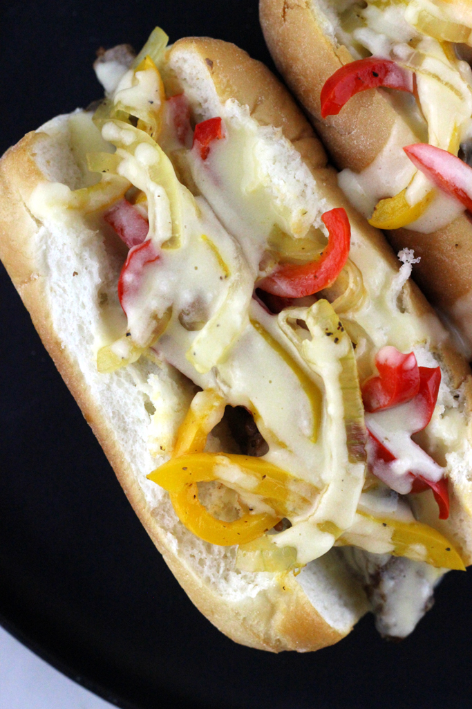 This is no ordinary cheesesteak here. This is The Best Philly Cheesesteak Recipe with Provolone Cheese Sauce.  Ribeye steak, caramelized onions and bell peppers topped with a gooey melty finger licking good cheese sauce! 