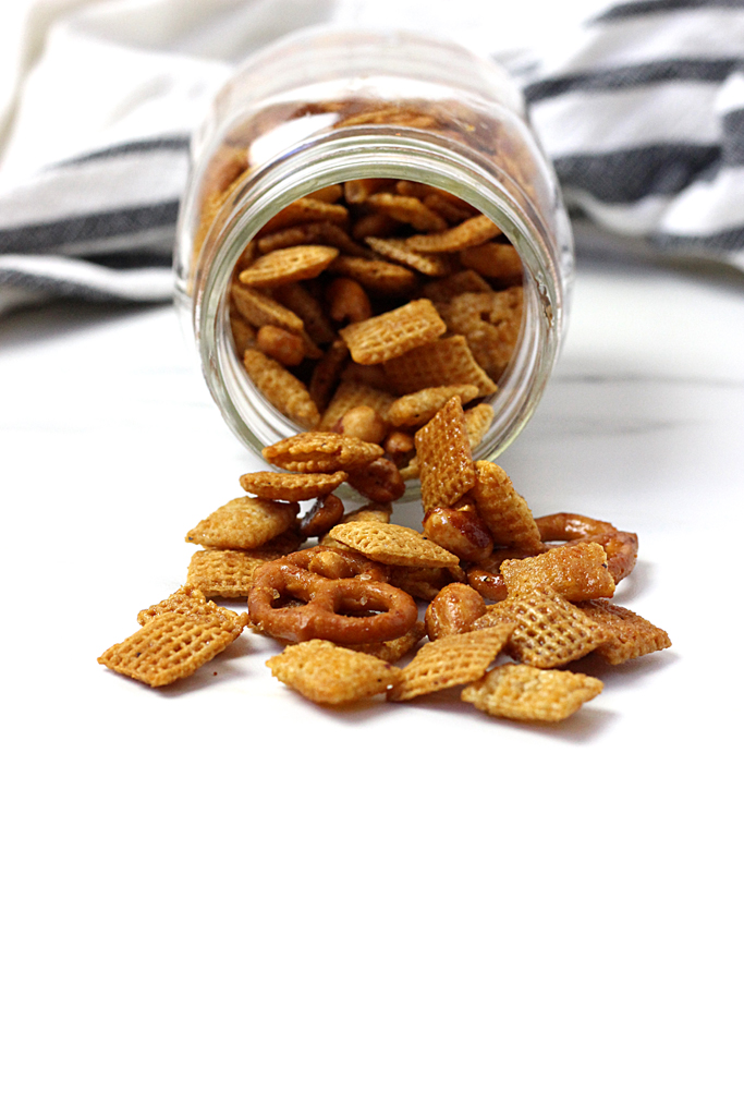 This sweet and spicy chex mix is the perfect blend of flavors. Ingredients include honey, hot sauce, and seasonings and it makes this Sweet Heat Chex Mix, your next addictive snack!
